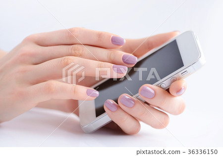 Women's hands holding mobile phone 36336150