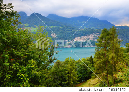 View into beautiful mountain lake on a cloudy day View into beautiful mountain lake on a cloudy day 36336152