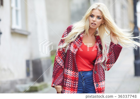 Young smiling blonde hair woman on the city streets on sunny day Young smiling blonde hair woman on the city streets on sunny day 36337748
