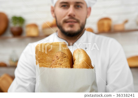 Young man working at his bakery 36338241