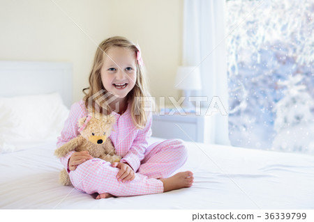 Kid in bed. Winter window. Child at home by snow. 36339799