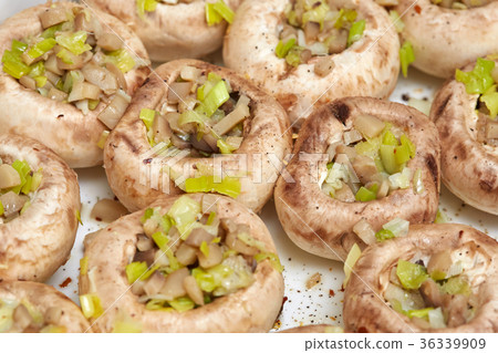 Raw champignon mushrooms, stuffed with vegetables Raw champignon mushrooms, stuffed with vegetables 36339909