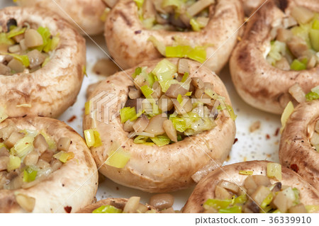 Raw champignon mushrooms, stuffed with vegetables Raw champignon mushrooms, stuffed with vegetables 36339910