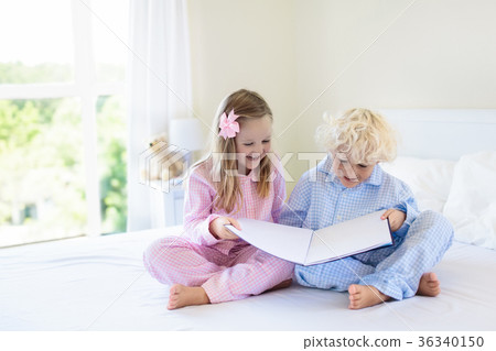 Kids in bed. Children in pajamas. Family bedroom. Kids in bed. Children in pajamas. Family bedroom. 36340150