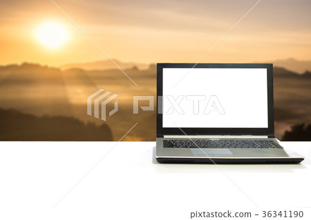 Laptop on white desk with blurred scene 36341190