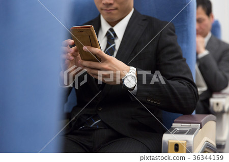 Airplane smartphone business trip business man 36344159