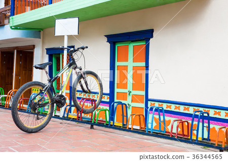Lonely bicycle parked on a colorful rack 36344565