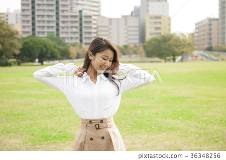 A young woman walking in the park A young woman walking in the park 36348256