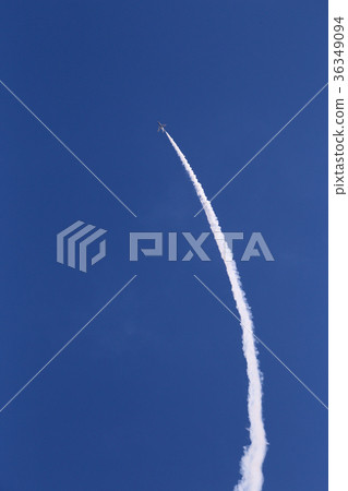 Airplane going up while putting smoke on the curve against the blue sky Airplane going up while putting smoke on the curve against the blue sky 36349094