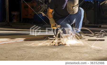 worker welding metal, focus on flashlight worker welding metal, focus on flashlight 36352986