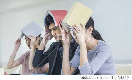 people student read book and hold over head 36353819