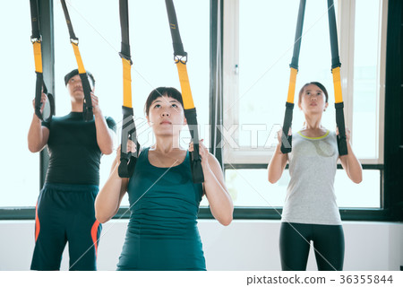 professional expert TRX pulls up and looks up 36355844