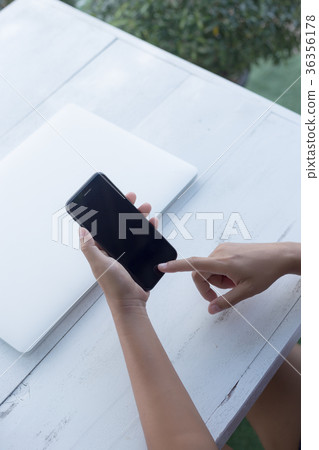hand using smart phone on desk vertical view hand using smart phone on desk vertical view 36356178