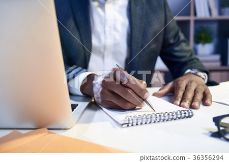 Skillful employee is taking some notes in his 36356294