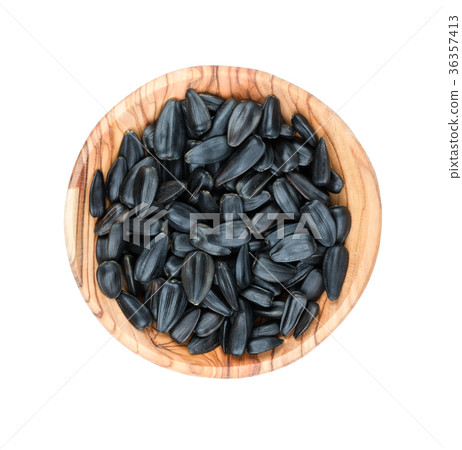 Sunflower seeds in a wooden bowl Sunflower seeds in a wooden bowl 36357413