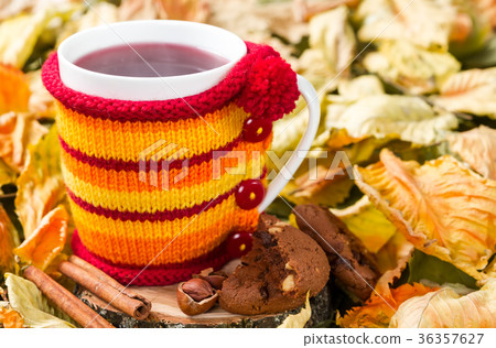 Fruit tea in a cup in a knitted cover 36357627
