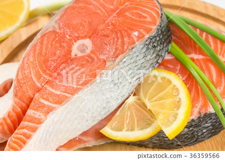 Salmon steak  on a wooden board 36359566