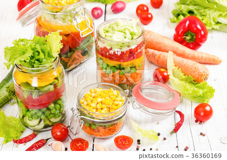 Colorful vegetables in glass jars  36360169