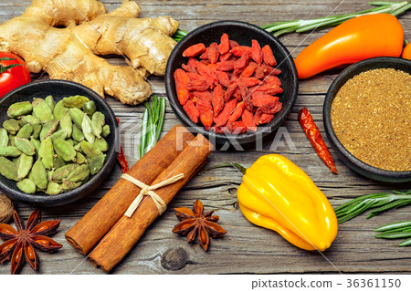 Spices and herbs on wooden background 36361150