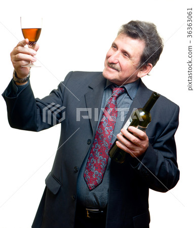 Elder businessman with glass of red wine 36363061
