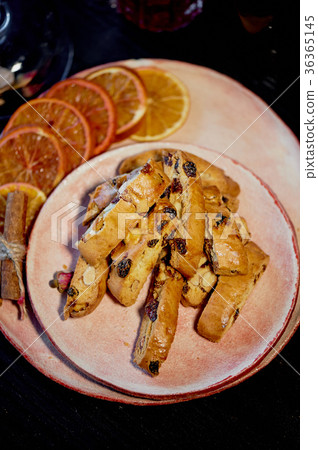 Cookie biscotti on a plate with orange slices.The Cookie biscotti on a plate with orange slices.The 36365145