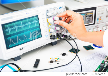 Oscilloscope is used by and electronic engineer in laboratory 36365244