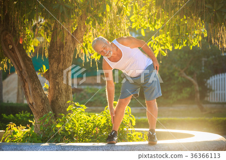 Old Man Does Exercises Bends Body to Foot 36366113