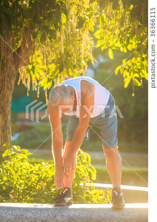 Old Man Does Morning Exercises Bends Body to Foot 36366115