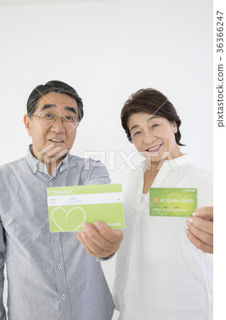 Senior couple with passbook and cash card Senior couple with passbook and cash card 36366247