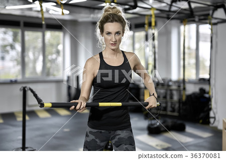 Sportive girl does exercise in gym 36370081