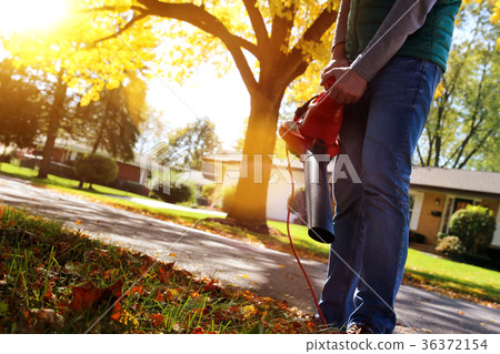 Man working with leaf blower Man working with leaf blower 36372154