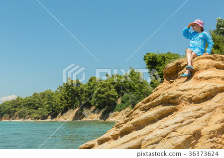 Tourist young girl on Aegean coast of Sithonia Tourist young girl on Aegean coast of Sithonia 36373624
