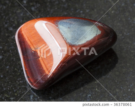 polished Ox's eye gemstone on dark background polished Ox's eye gemstone on dark background 36378061