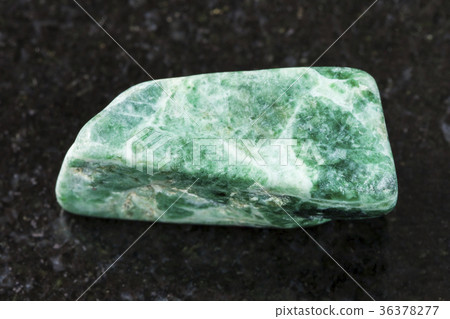 polished green jadeite stone on dark background 36378277