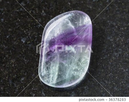 polished Fluorite gem stone on dark background polished Fluorite gem stone on dark background 36378283