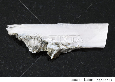 rough crystal of xonotlite gemstone on dark 36378623