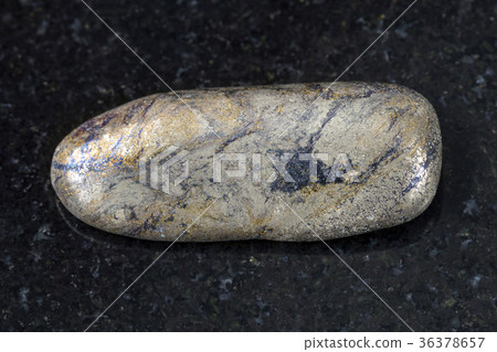 pebble of Arsenopyrite stone on dark background 36378657