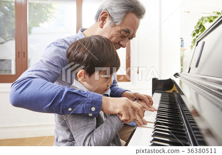 Grandfather, grandson, piano 36380511