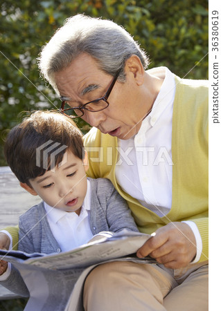 Grandfather, grandson, bench, newspaper Grandfather, grandson, bench, newspaper 36380619