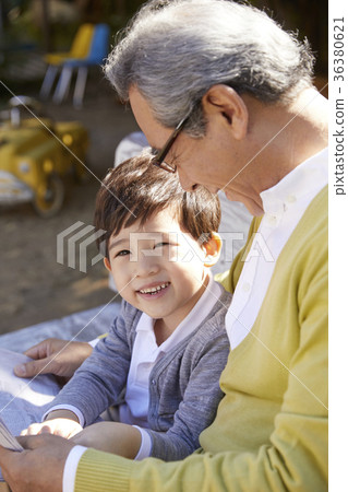 Grandfather, grandson, bench, newspaper 36380621