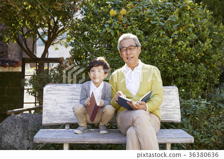 Grandfather, grandson, bench, book Grandfather, grandson, bench, book 36380636
