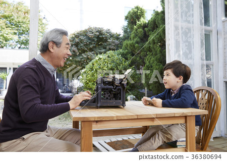 Grandfather, grandson, typewriter, cellphone 36380694