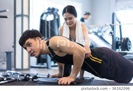 Handsome man working out with push up on bosu ball 36382096