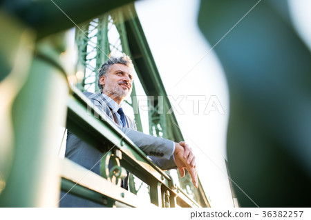 Mature businessman in a city. Mature businessman in a city. 36382257