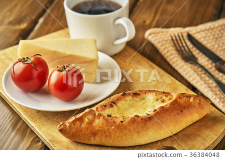 Cheese pie with tomatoes and cup of steaming tea Cheese pie with tomatoes and cup of steaming tea 36384048
