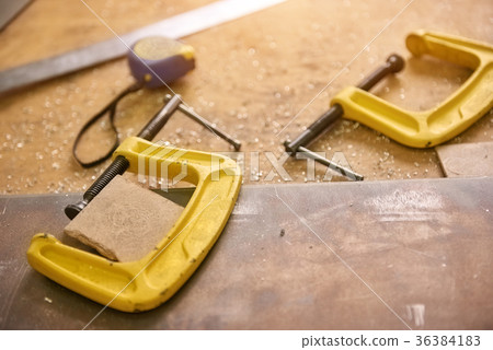 C-clamps on a table. C-clamps on a table. 36384183