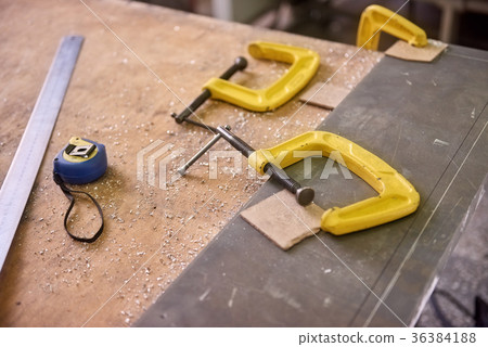 Two C-clamps, ruler and tape-measure. Two C-clamps, ruler and tape-measure. 36384188