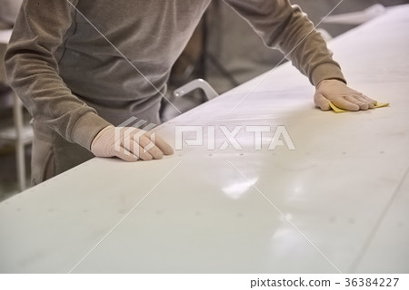 Man is cleaning white plate. Man is cleaning white plate. 36384227