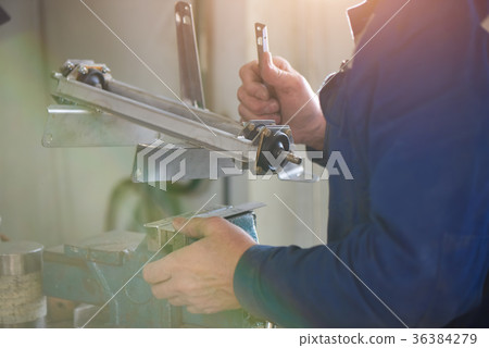 Man is going to clamp a detail. 36384279