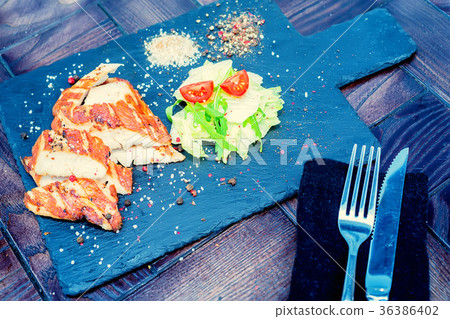 Grilled turkey fillet and vegetables in restaurant 36386402
